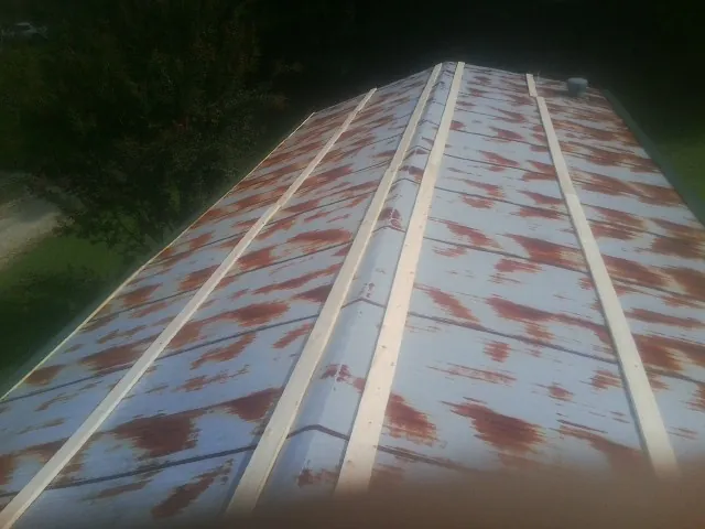 Rusted metal roof panels with new wood purlins before replacement — Storm Damage Roof Repair in Dunbarton by Roofing Brothers