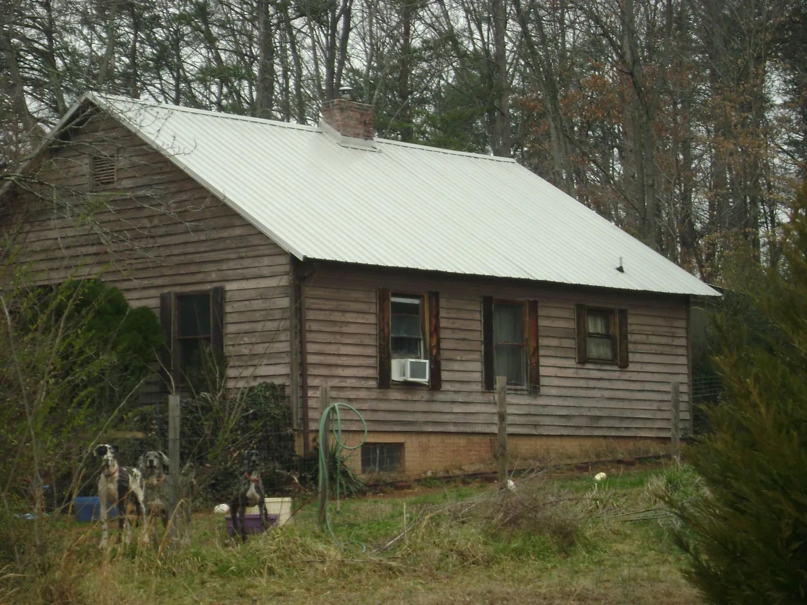 White metal roof on an old wood sided farmhouse, from a Metal Roof Installation job in Dunbarton